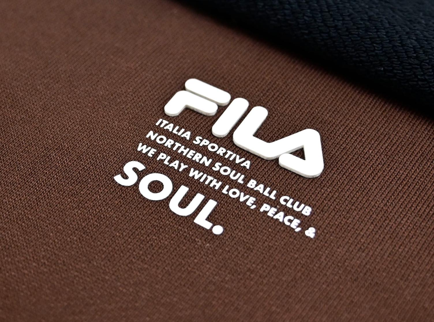 FILA logo and text transfer sample on brown fabric.