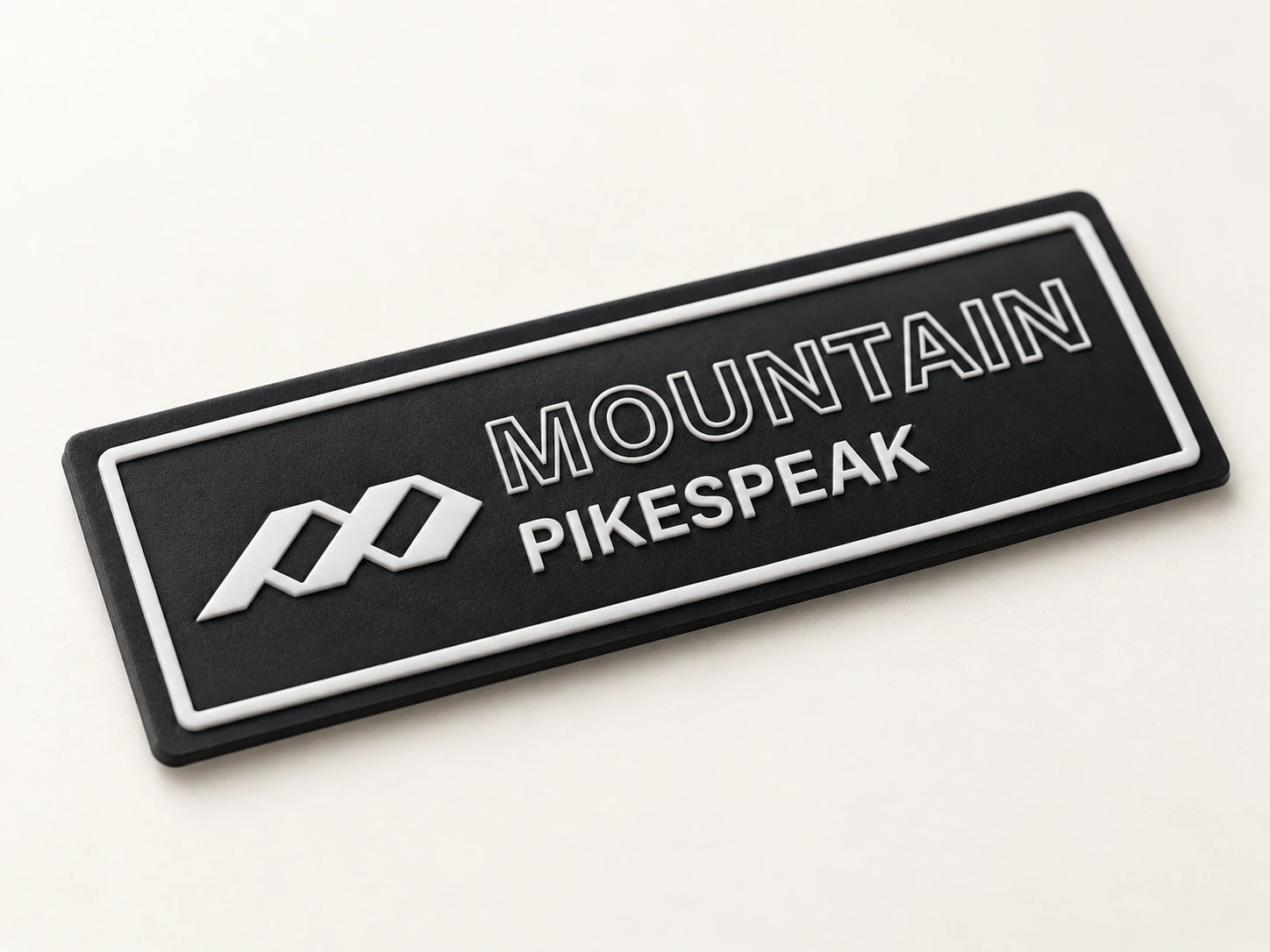A black and white dimensional TPU label with the existing PIKESPEAK artwork.